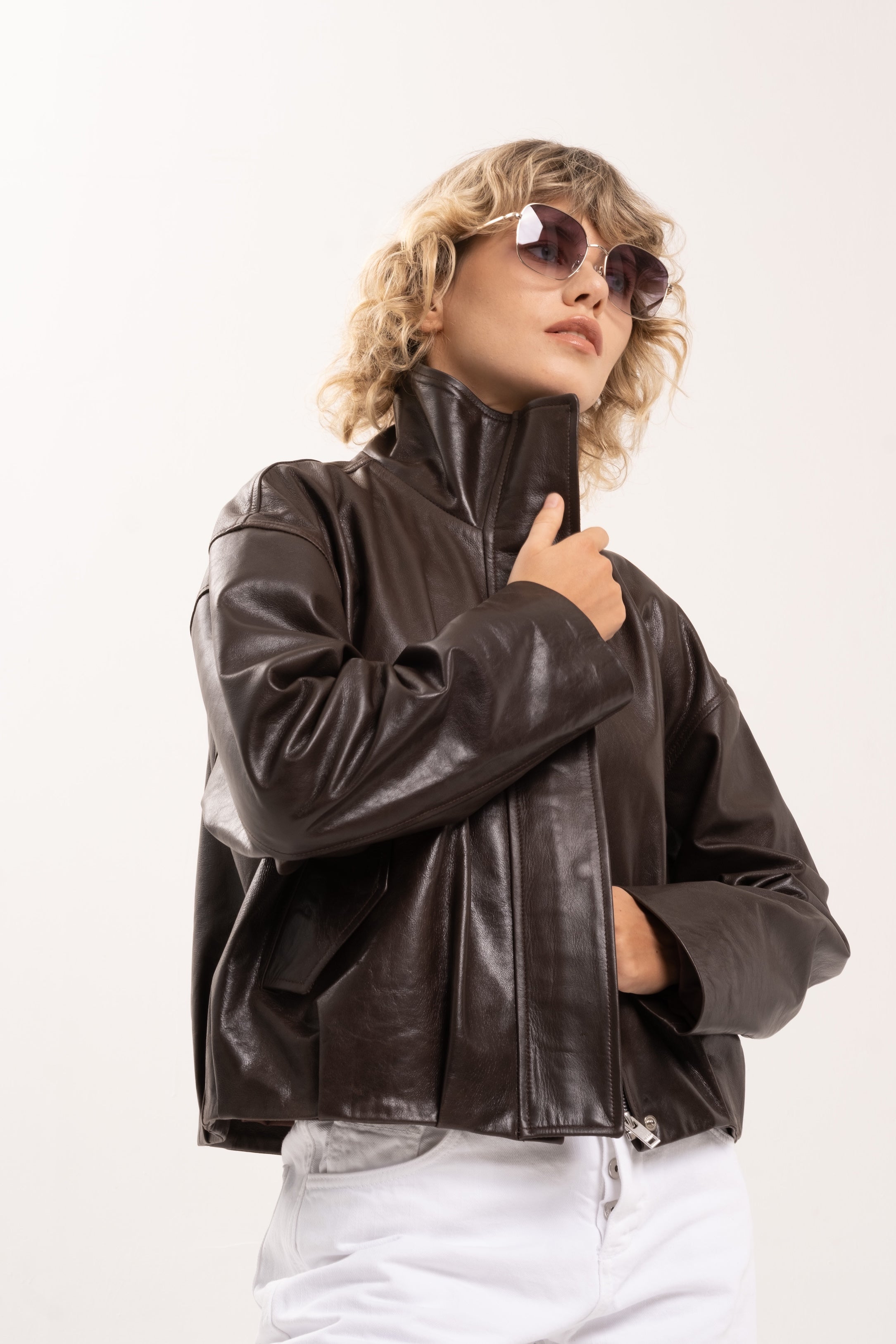 Close-up of the sculptural funnel neckline and sheepskin leather on the Arabella jacket