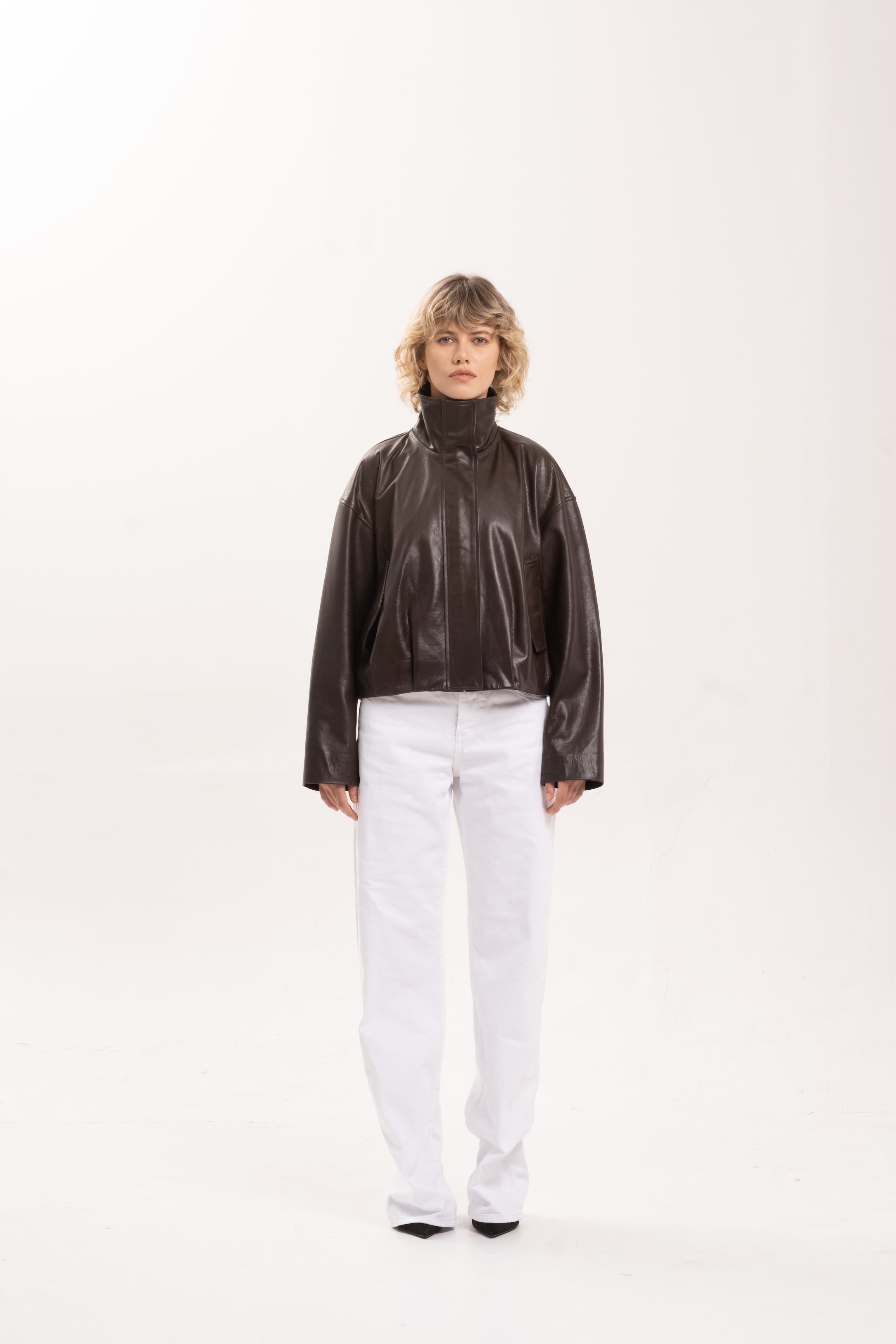 Model wearing the 2NDSKIN Arabella funnel neck jacket in Bitter Chocolate sheepskin leather